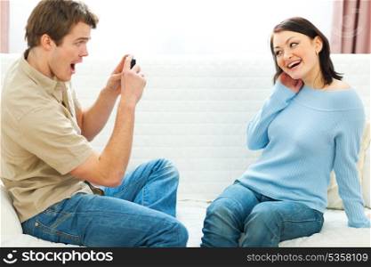 Happy young couple making fun photos