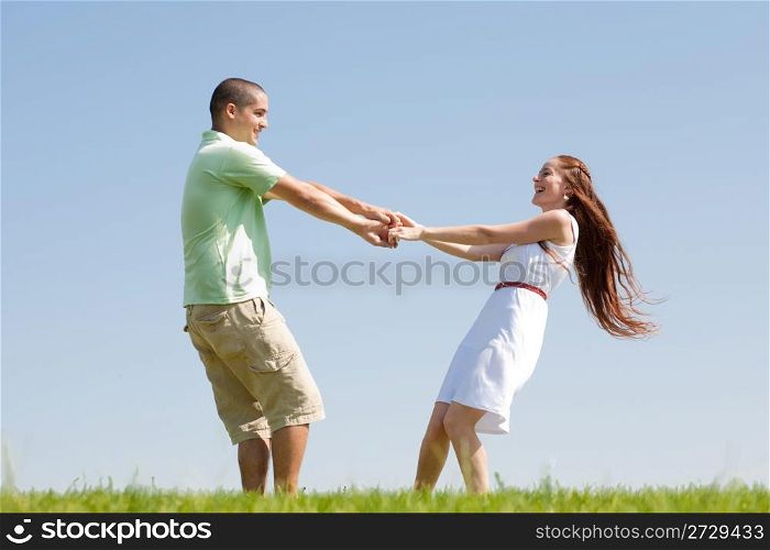 happy young couple play at park