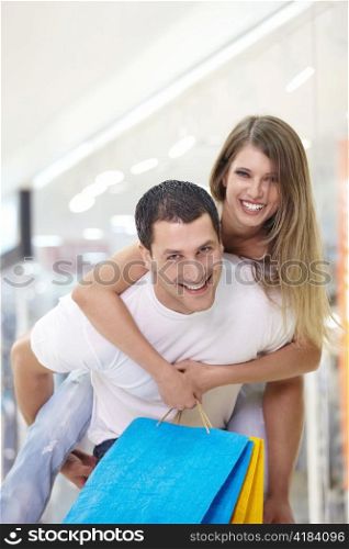 Happy young couple playing the fool in the store