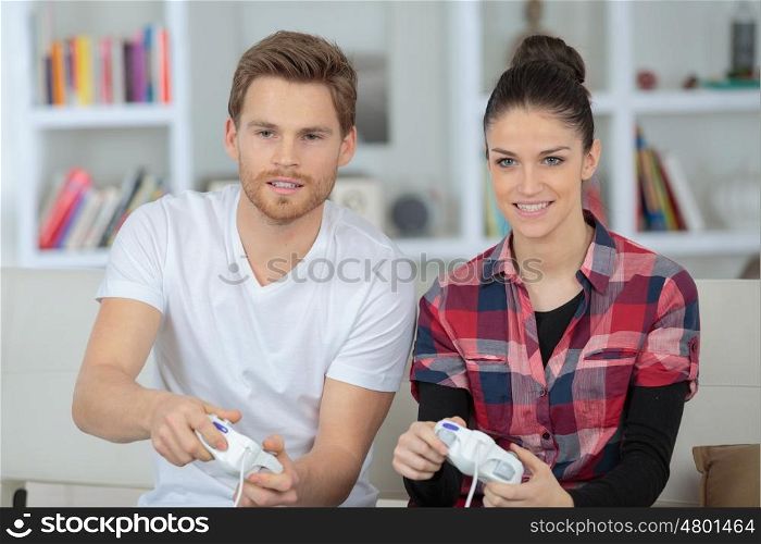 happy young couple playing video games