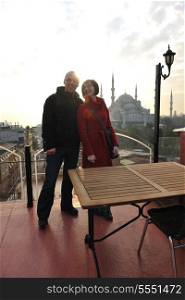 happy young couple portrait outdoor at sunny day in istanbul turkey with beautiful old mosque with sunset in background
