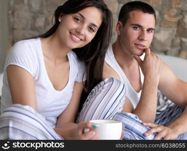 happy young couple relax and have fun in bed