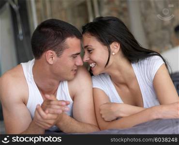 happy young couple relax and have fun in bed