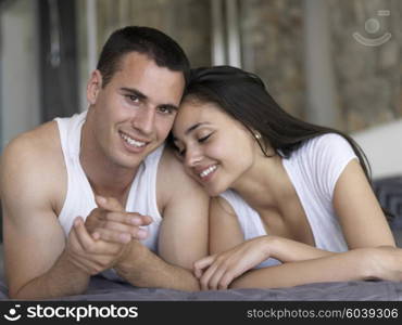 happy young couple relax and have fun in bed