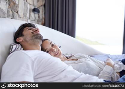 happy young couple relax and have fun in bed