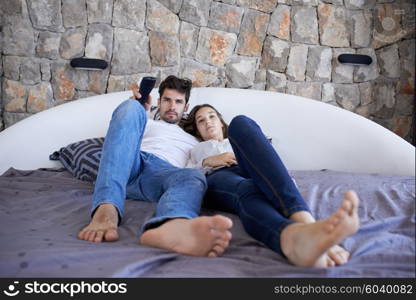 happy young couple relax and have fun in bed