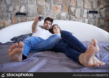 happy young couple relax and have fun in bed