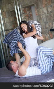 happy young couple relax and have fun in bed