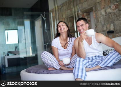 happy young couple relax and have fun in bed