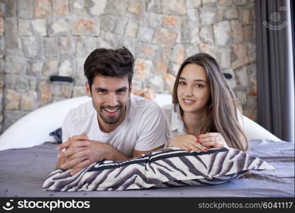 happy young couple relax and have fun in bed