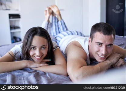 happy young couple relax and have fun in bed