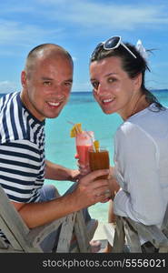 happy young couple relax and take fresh drink at summer vacation