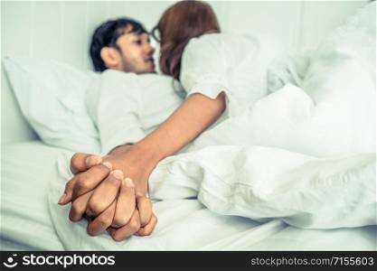 Happy young couple relaxing at home in the morning.. Romantic love of young couple in the bedroom.