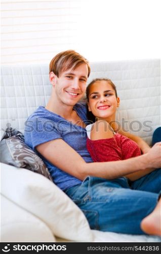 Happy young couple relaxing at home&#xA;