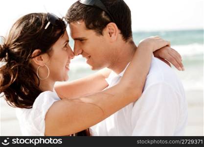 Happy young couple romancing eachother at the beach,outdoor