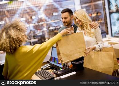 Happy young couple shopping at a clothing store