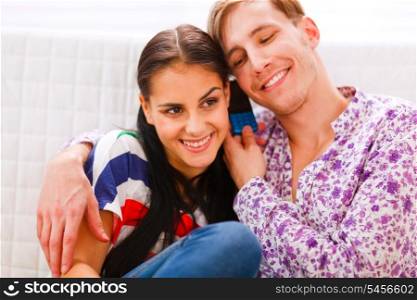 Happy young couple speaking together on cell phone&#xA;