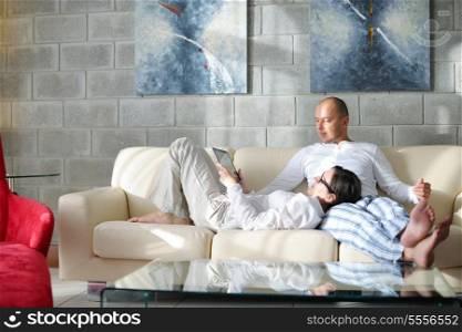 happy young Couple Using Digital Tablet computer At Home