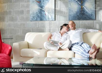 happy young Couple Using Digital Tablet computer At Home