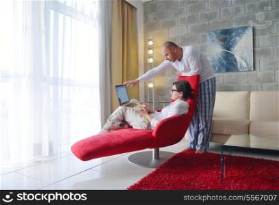 happy young Couple Using Laptop computer At Home