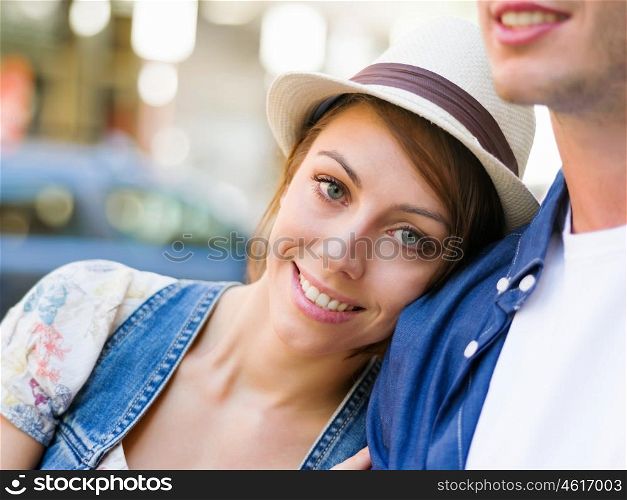 Happy young couple walking in city. Happy smiling young couple walking in city