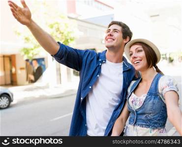 Happy young couple walking in city. Happy smiling young couple walking in city