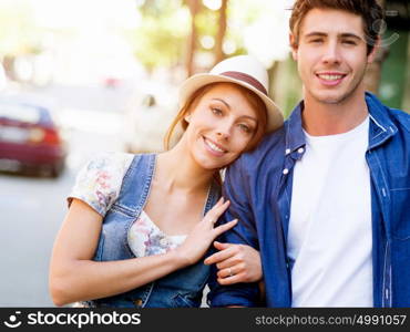 Happy young couple walking in city. Happy smiling young couple walking in city