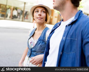 Happy young couple walking in city. Happy smiling young couple walking in city