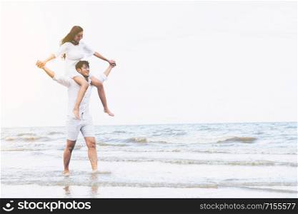 Happy young couple walking on the beach during honeymoon travel vacation.. Couple going honeymoon on tropical beach in summer