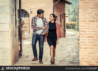 Happy young couple walking on the street in old town. Travel and dating concept.