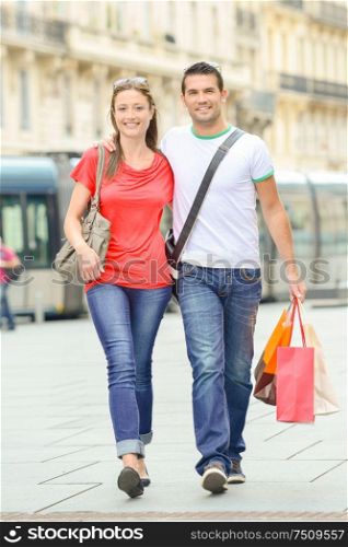 Happy young couple walking the streets