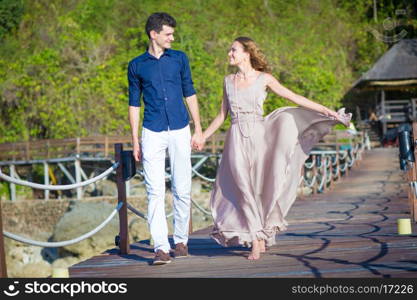 Happy Young Couple Walking Together in a Green Park