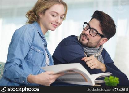 happy young couple with book