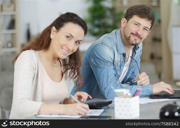 happy young couple with laptop at home