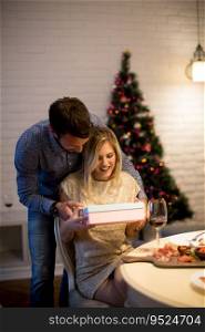 Happy young couple with present at Christmas time