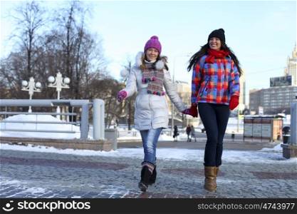 Happy young couple women in winter street