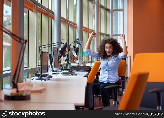 happy young curly business woman in the modern office