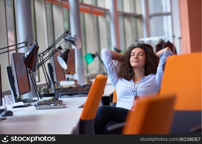 happy young curly business woman in the modern office