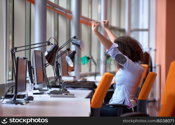 happy young curly business woman in the modern office