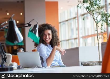 happy young curly business woman in the modern office