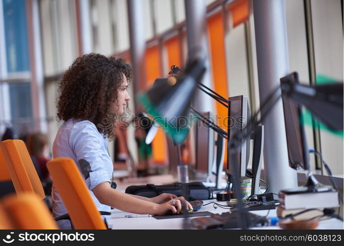 happy young curly business woman in the modern office