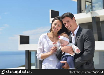 happy young family couple with beautiful new born baby have fun at home