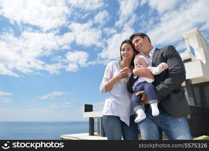 happy young family couple with beautiful new born baby have fun at home