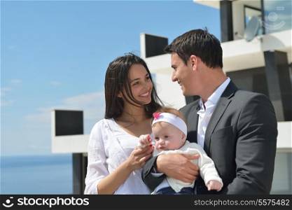 happy young family couple with beautiful new born baby have fun at home