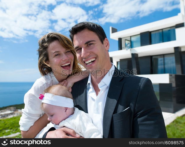 happy young family couple with beautiful new born baby have fun at modern home