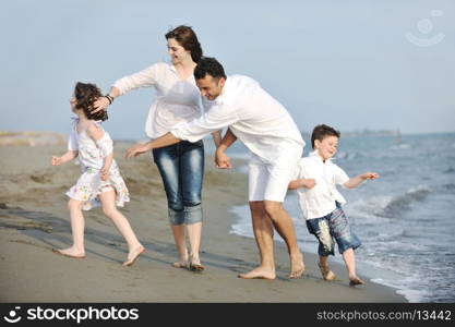 happy young family have fun and live healthy lifestyle on beach