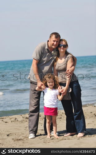 happy young family have fun and live healthy lifestyle on beach