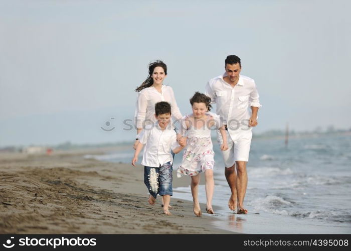 happy young family have fun and live healthy lifestyle on beach