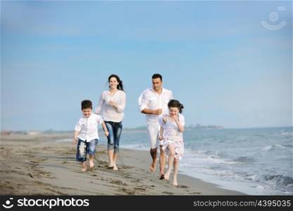 happy young family have fun and live healthy lifestyle on beach