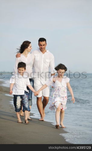 happy young family have fun and live healthy lifestyle on beach